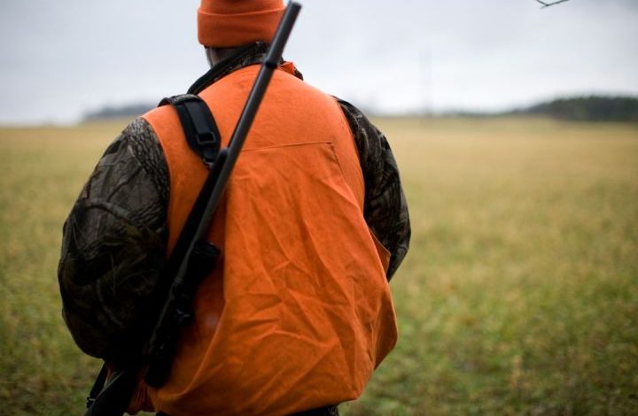 Hunter - man in orange and black backpack