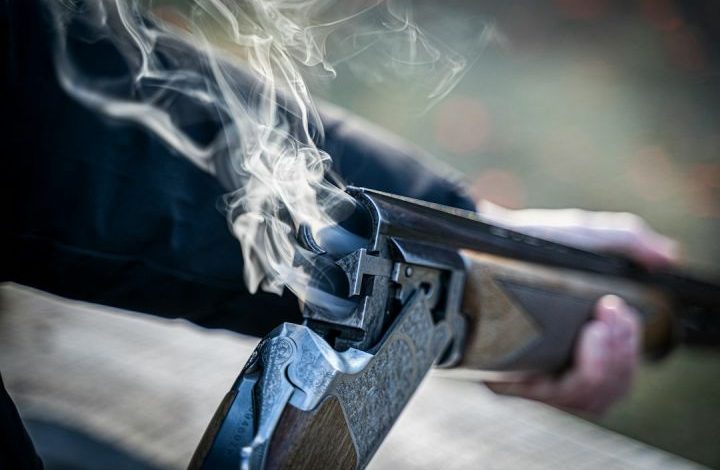 Hunting - black semi automatic pistol with white smoke