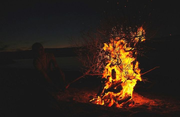Outdoor Fire - man in front of lighted bonfire