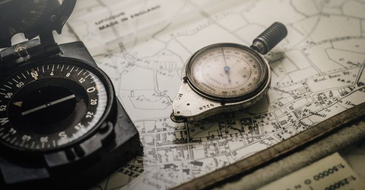 Navigation - Shallow Focus Photography of Black and Silver Compasses on Top of Map